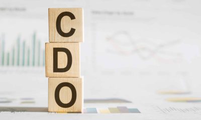CDO - text on wooden cubes, on office table background. collateralized debt obligations or chief data officer concept